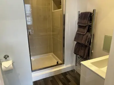 a shower with a glass door in a bathroom at Wenden Guest House in Newquay