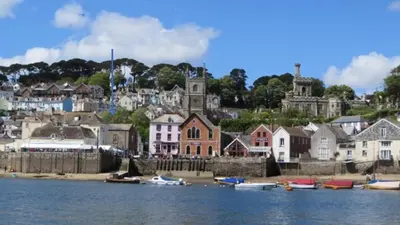 a group of houses and boats in the water at Saffron House in Fowey