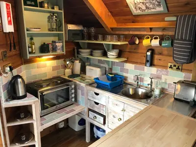 a small kitchen with a sink and a counter at Enys Boathouse in Porkellis