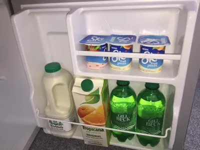 an open refrigerator filled with milk and juice at Rosenn Teyr in St. Agnes