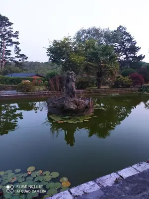 a statue sitting in the middle of a pond at Peacock Lodge - Sleeps 4 - 2 Bedrooms in East Looe