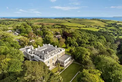 an aerial view of a large house in the forest at Trenython Manor Resort in Fowey