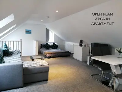 a living room with a couch and a table at Boleyn house in Bodmin
