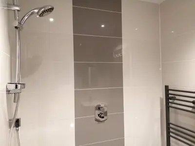 a shower with a shower head in a bathroom at Boleyn house in Bodmin