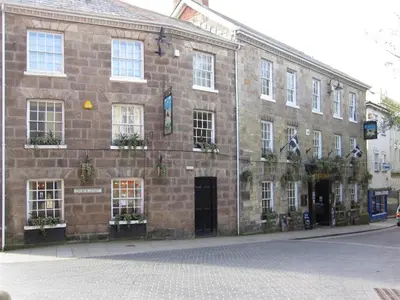 a large brick building with windows on a street at The White Hart Hotel in St Austell