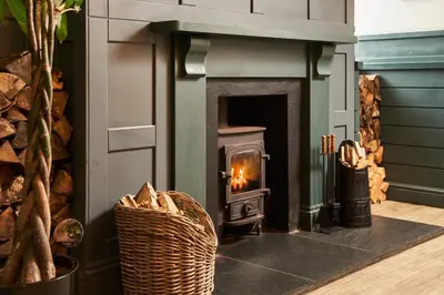 a fireplace in a living room with a fire place at Rashleigh Arms in St Austell