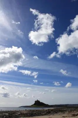 a person is flying a kite on the beach at Wheal Rodney Holiday Park in Marazion