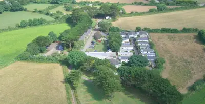 an aerial view of a house in a field at Wheal Rodney Holiday Park in Marazion