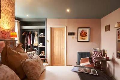 a bedroom with a bed and a closet at Harbour Inn in Porthleven
