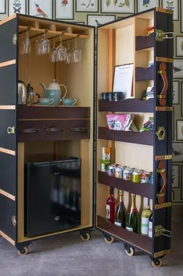a kitchen with a shelf with bottles of wine at Penventon Park Hotel in Redruth
