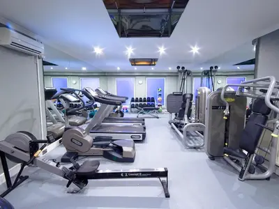 a gym with several treadmills and cardio machines at Penventon Park Hotel in Redruth