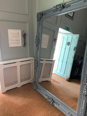 a mirror in a room with a door in it at Boscundle Manor in St Austell