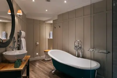 a bathroom with a tub and a sink at Greenbank Hotel in Falmouth