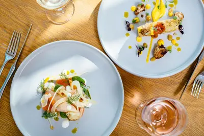 three plates of food on a wooden table at Greenbank Hotel in Falmouth