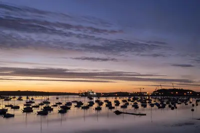 a group of boats in the water at sunset at Greenbank Hotel in Falmouth