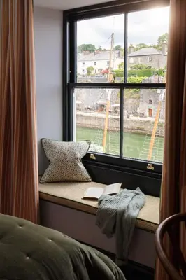 a window seat with a book and a book at Pier House in St Austell