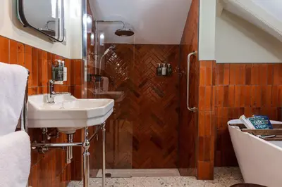a bathroom with a sink and a shower at Pier House in St Austell