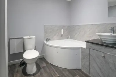 a bathroom with a tub and a toilet and a sink at Trethorne Hotel & Golf Club in Launceston