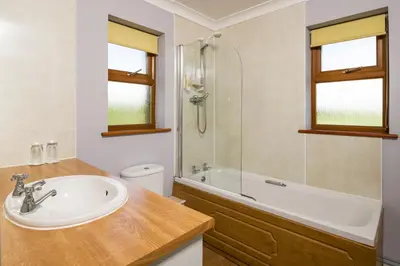 a bathroom with a sink and a shower and a tub at Trethorne Hotel & Golf Club in Launceston