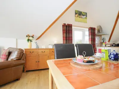 a kitchen and dining room with a table and chairs at Treview in Launceston