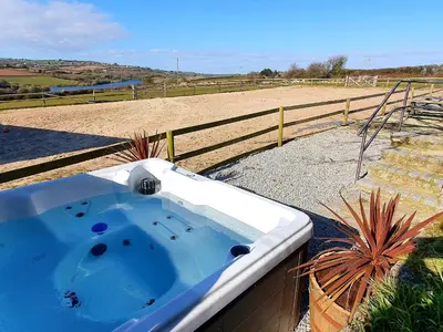 a bath tub in a yard next to a field at Dexter in Penryn