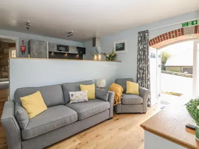 a living room with a couch and two chairs at Dexter in Penryn