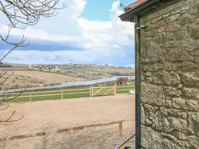 a stone building with a view of a river at Dexter in Penryn