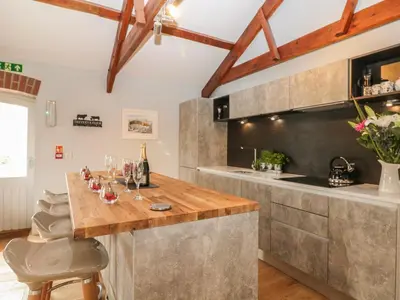 a kitchen with a wooden counter with wine glasses on it at Argal in Penryn
