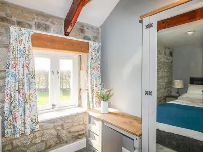 a bedroom with a bed and a window at Helford in Penryn