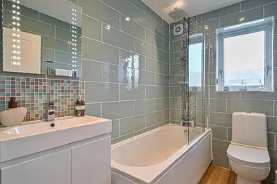 a bathroom with a tub and a toilet and a sink at Sunset View in Newquay