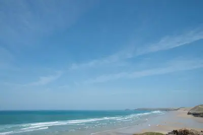 a view of a beach with people on it at Spiral View in Perranporth