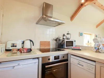 a kitchen with a sink and a stove at Mithian Cottage in St. Agnes