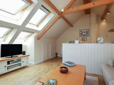 a living room with skylights and a flat screen tv at Mithian Cottage in St. Agnes