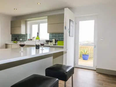 a kitchen with a counter with two glasses of wine at Bethany Bay View in Cubert