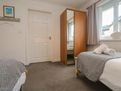 a bedroom with two beds and a mirror at Bethany Bay View in Cubert