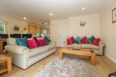 a living room with two couches and a coffee table at Bramble Cottage in Falmouth