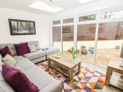 a living room with a couch and a table at Higher Kernick Stable in Bodmin