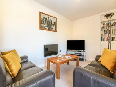 a living room with two couches and a coffee table at Higher Kernick Stable in Bodmin