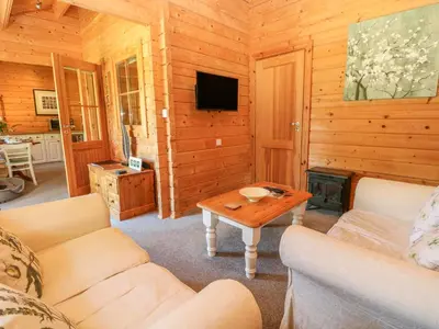 a living room with a couch and a coffee table at Pond Cabin in Stithians