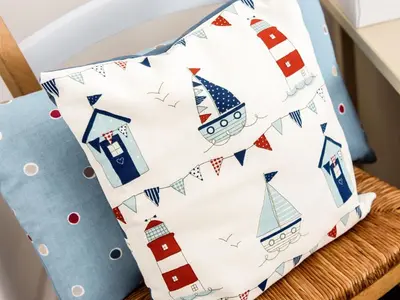 a cushion with a sailboat pattern on a chair at The Old Sweet Shop in Par