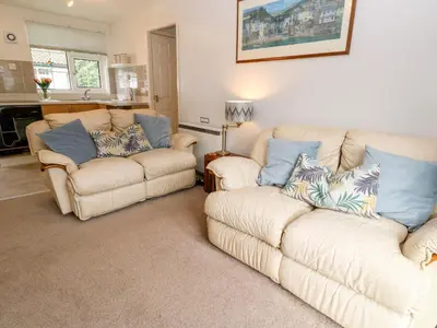 a living room with two chairs and a couch at Brook Haven in Saint Cleer