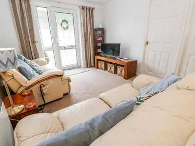 a living room with two couches and a television at Brook Haven in Saint Cleer