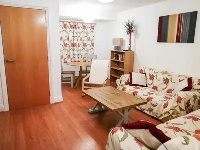 a living room with a couch and a table at 4 Bredon Court in Newquay