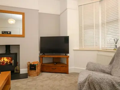 a living room with a flat screen tv and a fireplace at Pound Rocks in Tintagel
