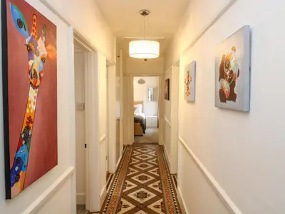 a hallway with art on the walls and a hallway with a hallway at Pound Rocks in Tintagel