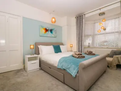 a bedroom with a bed and a couch at Pound Rocks in Tintagel