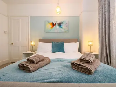 a bedroom with a bed with towels on it at Pound Rocks in Tintagel