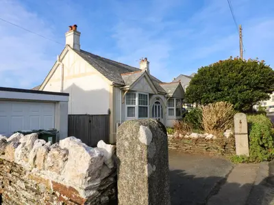 a house with a stone fence in front of it at Pound Rocks in Tintagel