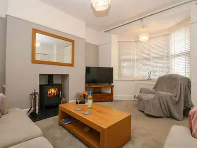 a living room with a coffee table and a fireplace at Pound Rocks in Tintagel