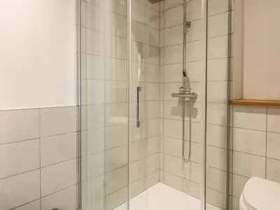 a shower with a glass door in a bathroom at Higher Kernick Farm in Launceston